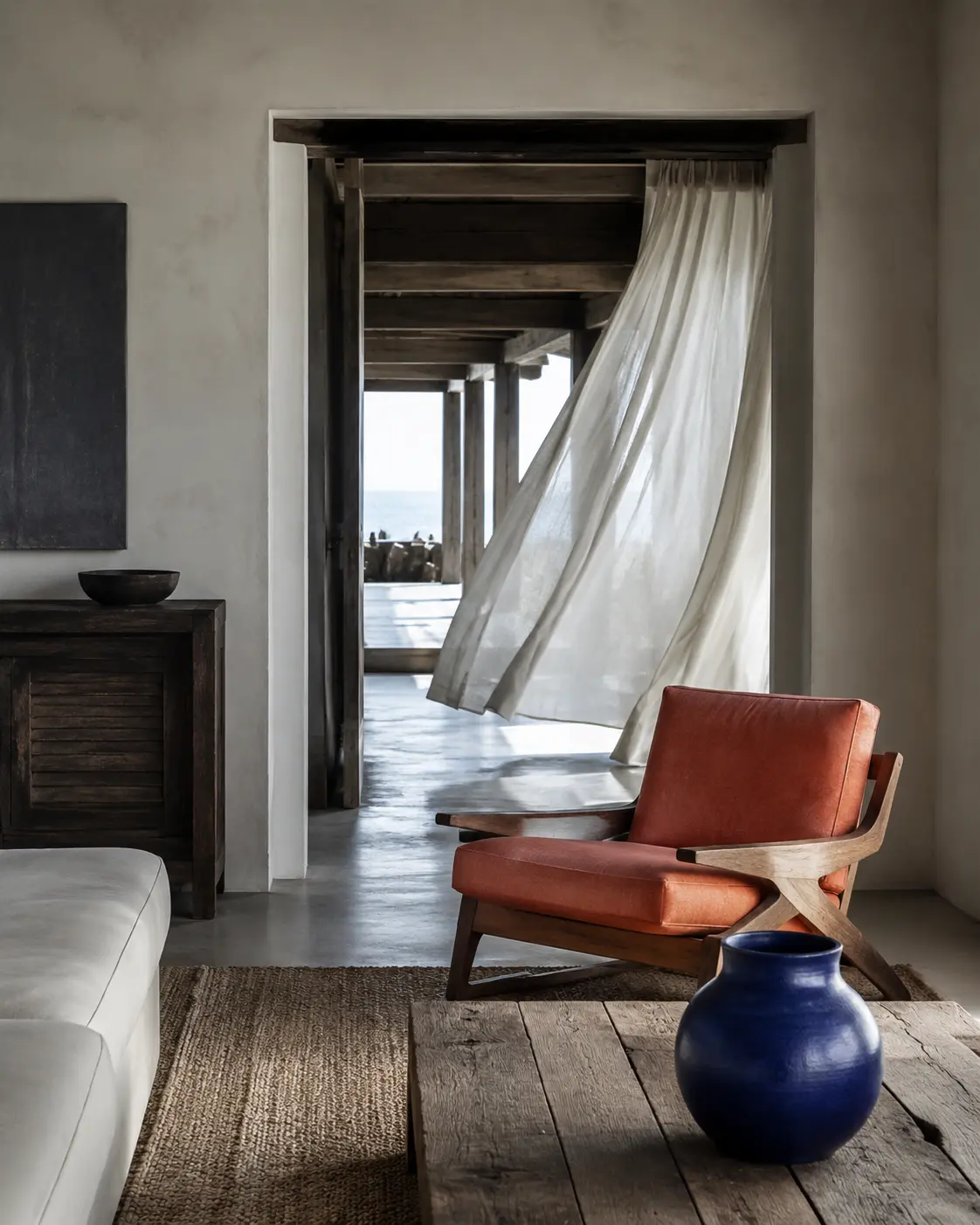 Modern ocean-led room with cross-breeze curtains and no nautical clichés