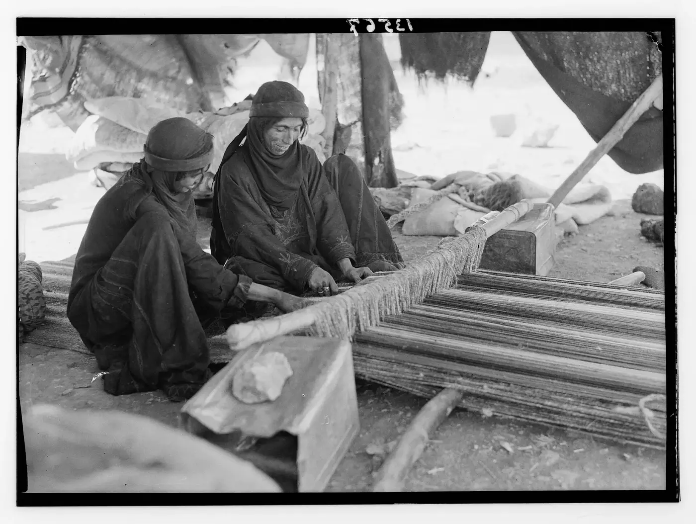 Bedouin women weaving on a ground loom between 1940 and 1946