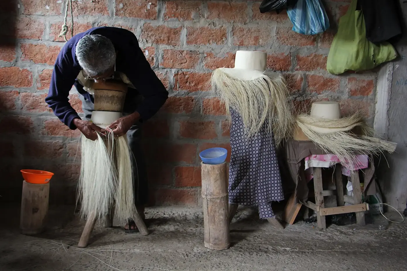 A master craftsperson weaving a toquilla straw hat in Ecuador