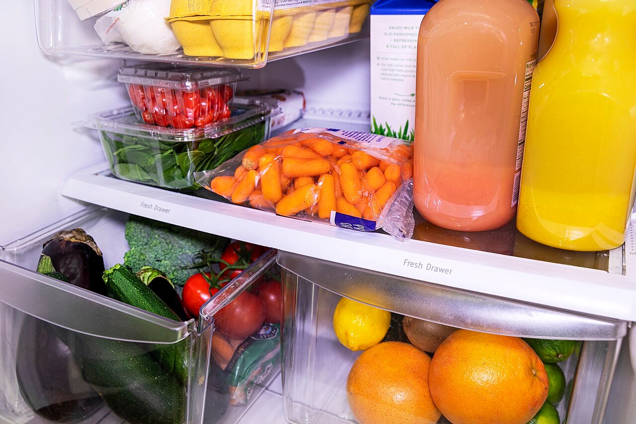 Open refrigerator stocked with fruits and vegetables