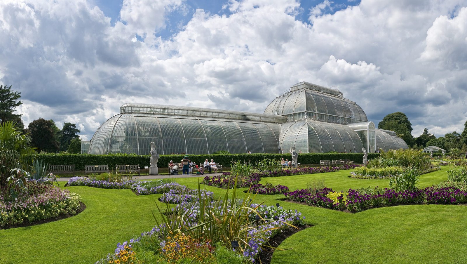 Palm House and formal flower beds at Royal Botanic Gardens, Kew in London