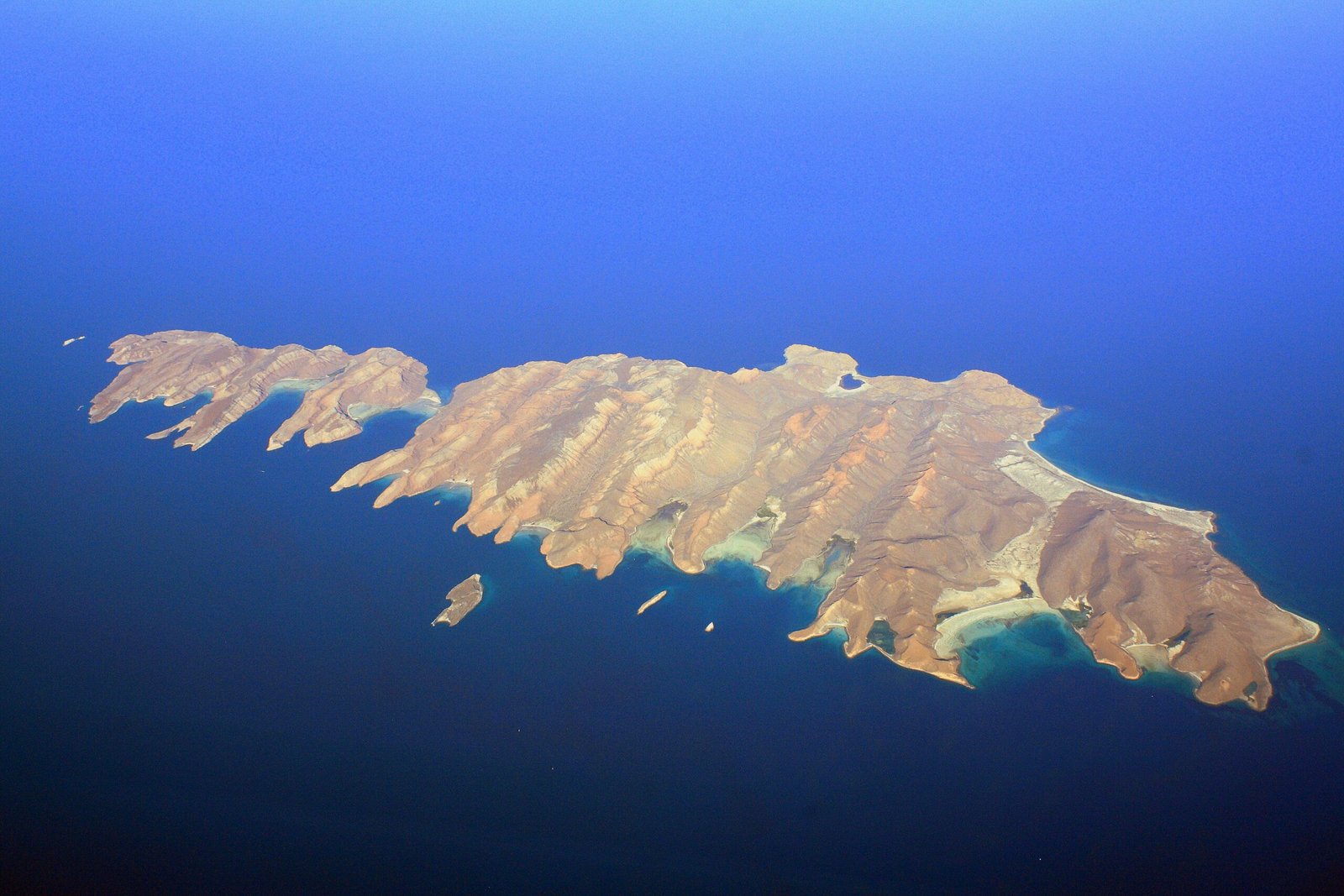 Aerial view of arid Espíritu Santo and Partida islands edged by deep blue and turquoise Gulf of California water
