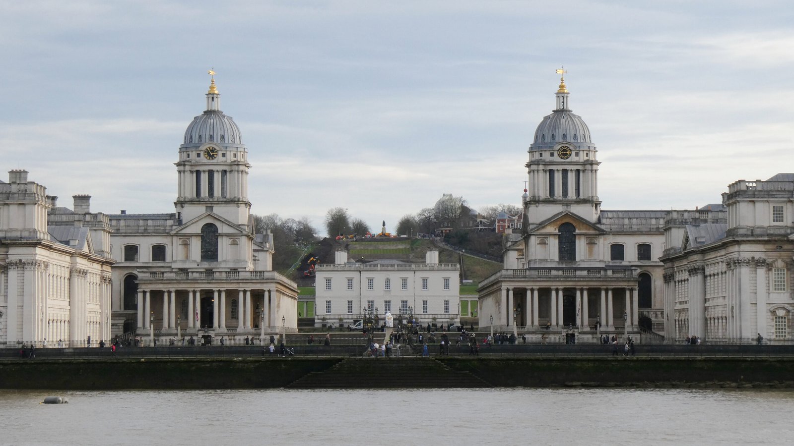 The historic twin-domed Old Royal Naval College buildings seen from across the River Thames
