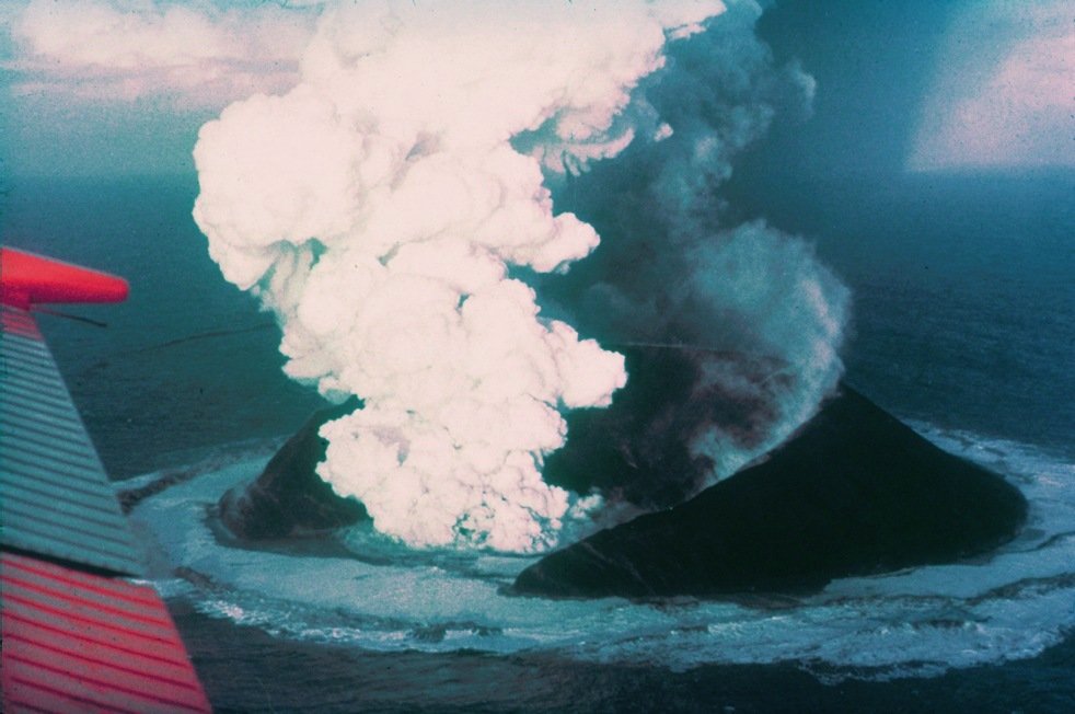 Surtsey erupting from the North Atlantic in 1963 with volcanic plumes rising above the sea
